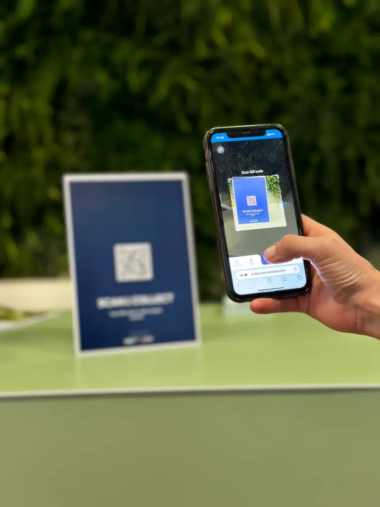 Visitor scanning a Scanpoint QR code with their phone at an exhibition stand
